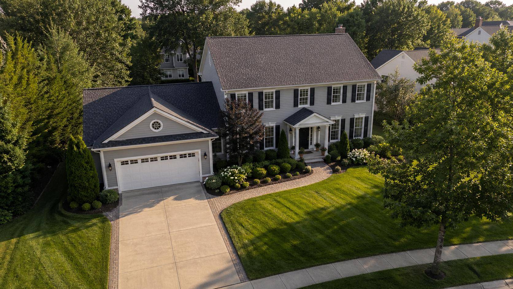 Aerial view of a well-maintained West Michigan home with manicured landscaping.